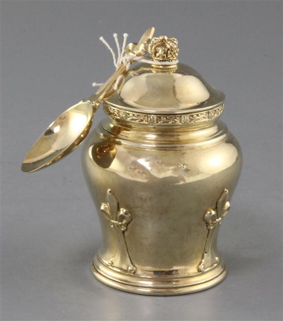 A 1930s silver gilt tea caddy and cover, with matching caddy spoon, by Goldsmiths & Silversmiths Co Ltd, 6 oz.